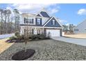 Well-maintained two story home with blue and gray accent exterior and a two-car garage at 192 Springhill Ln, Garner, NC 27529