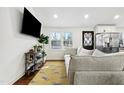 Bright and airy living room featuring a large comfortable couch, hardwood floors, and modern decor at 217 Northfield Dr, Raleigh, NC 27609