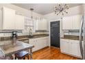 Modern kitchen features white cabinets, stainless steel appliances, and a chalkboard menu at 24 Carter Dr, Sanford, NC 27332