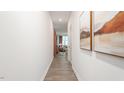Inviting hallway featuring sleek, modern flooring and leads into a bright living space at 251 Perseus St, Angier, NC 27501