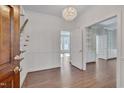 Bright foyer featuring hardwood floors, chandelier, stairs, and entry to other rooms at 3023 Whitfield Rd, Chapel Hill, NC 27514