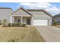 Charming single-story home with gray siding, white trim, a manicured lawn, and an attached two-car garage at 3333 Sandy Meadows Dr, Fuquay Varina, NC 27526