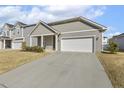 Charming single-story home with gray siding, white trim, a manicured lawn, and an attached two-car garage at 3333 Sandy Meadows Dr, Fuquay Varina, NC 27526