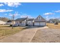 Charming single-story home with a front porch and detached two-car garage at 43 Old Halifax Rd, Louisburg, NC 27549