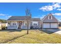 Charming single-story home with a front porch and two-car detached garage at 43 Old Halifax Rd, Louisburg, NC 27549