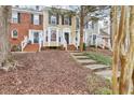 Charming townhomes with brick and siding exteriors and well-maintained front lawns and landscaped front yard at 4523 Hamptonshire Dr, Raleigh, NC 27613