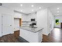 Bright kitchen features white cabinets, stainless steel appliances, and granite countertops at 46 Shay St, Angier, NC 27501