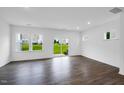 Bright living room with hardwood floors and sliding glass door leading to the patio at 46 Shay St, Angier, NC 27501