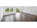 Open living room boasts hardwood floors and sliding glass doors to the backyard at 46 Shay St, Angier, NC 27501