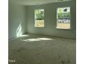 Bright, unfinished bedroom with natural light from two windows; a blank canvas awaiting personalization at 58 Shay St, Angier, NC 27501
