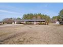 One-story brick home features a covered carport and is situated on a spacious lawn at 6605 Pearces Rd, Louisburg, NC 27549