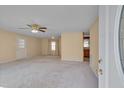 Inviting living room with neutral carpet, ceiling fan, and natural light streaming through the window at 6605 Pearces Rd, Louisburg, NC 27549