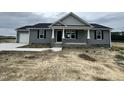 Charming single-story home features a gray exterior, stone accents, and a cozy front porch at 82 Asher Pointe Way, Benson, NC 27504
