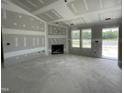 Unfinished living room with a fireplace, large windows, and natural light at 82 Asher Pointe Way, Benson, NC 27504