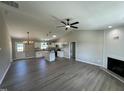 Spacious living room and kitchen area featuring vaulted ceilings, modern fixtures, and hardwood floors at 82 Asher Pointe Way, Benson, NC 27504