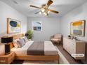 A stylish main bedroom with a ceiling fan, neutral decor, and carpet, creating a calming personal space at 1004 Carlisle St, Raleigh, NC 27610