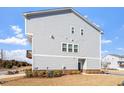 Townhome featuring a siding exterior, brick accents, and manicured lawn at 1018 Salt Glaze Ln, Cary, NC 27519