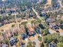Aerial view of an upscale community with manicured golf course and tree lined streets at 104 E Seve Ct, Morrisville, NC 27560