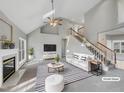 Bright living room boasts high ceilings, a fireplace, and staircase to the upper level at 106 Trumbell Cir, Morrisville, NC 27560