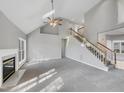 Open living room with high ceilings, a fireplace, and staircase leading upstairs at 106 Trumbell Cir, Morrisville, NC 27560
