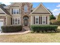Inviting home featuring stone accents around front entry with mature landscaping at 109 Coffeeberry Ct, Garner, NC 27529