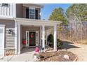 Cozy front porch with stylish decor, columns, and a welcoming entrance to the home at 127 Lakemont Dr, Clayton, NC 27520