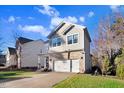 Stylish two-story home featuring stone accents, a covered front porch, and a two-car garage at 13 Piccadilly Ct, Durham, NC 27713