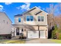 Attractive two-story home featuring stone accents, a covered front porch, and a two-car garage at 13 Piccadilly Ct, Durham, NC 27713
