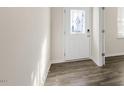 Inviting entryway showcasing wood-look flooring and a decorative glass front door at 132 Paper Birch Way, Fuquay Varina, NC 27526