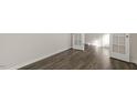 Bright room featuring hardwood style floors and double doors, perfect for an office or den at 132 Paper Birch Way, Fuquay Varina, NC 27526