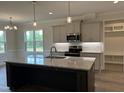 Kitchen featuring granite countertops, stainless steel appliances, and a large island at 143 Prency Ln, Middlesex, NC 27557