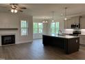 Open-concept living room with a fireplace, and island with stainless steel appliances at 143 Prency Ln, Middlesex, NC 27557