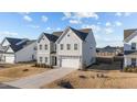 Charming two-story home with neutral siding, well-kept lawn, and attached two car garage at 158 Arlie Ln, Lillington, NC 27546