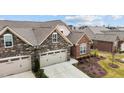 Aerial view of the home showcasing its architectural details, stone and brick accents, and well-maintained landscaping at 170 Dunvegan Ln, Burlington, NC 27215
