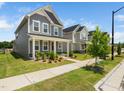 Beautiful two-story house featuring a covered porch and well-maintained lawn at 1981 Rosedale Ridge Ave, Wake Forest, NC 27587