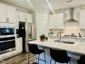 Spacious kitchen with white cabinets, quartz countertops, and stainless steel appliances at 1981 Rosedale Ridge Ave, Wake Forest, NC 27587