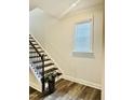 Staircase with wood treads and white risers complemented by a modern railing at 1981 Rosedale Ridge Ave, Wake Forest, NC 27587