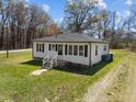 View of charming house featuring white siding, black shutters, and a landscaped front yard at 202 Harper Rd, Hillsborough, NC 27278