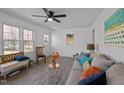 Bright living room with ample seating, a ceiling fan, and natural light at 202 Harper Rd, Hillsborough, NC 27278