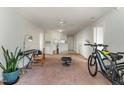 An open-concept living space with a partial view of the kitchen at 2020 University Woods Rd # 203, Raleigh, NC 27603