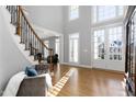 Bright and airy foyer with hardwood floors, staircase, and an abundance of natural light at 2110 Crigan Bluff Dr, Cary, NC 27513