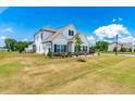 Spacious two-story home with a well-maintained lawn, landscaping, and a view of the neighborhood at 23 Tullamore Ln, Four Oaks, NC 27524