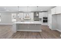 Modern kitchen featuring white cabinets, a large island, and stainless steel appliances at 2321 Calluna Ct, Fuquay Varina, NC 27526
