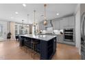 Spacious open-concept kitchen with a large island, pendant lighting, and access to the dining area and living room at 2609 Aster Ct, Apex, NC 27502
