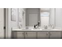 Modern bathroom featuring a double vanity with beautiful counter tops, a large mirror, and contemporary fixtures at 264 Beacon Dr, Pittsboro, NC 27312