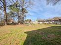 Spacious backyard with mature trees and a playset at 2918 Avalon Rd, Rocky Mount, NC 27801