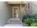 Front entrance showcasing stone steps, pillars, and a modern door with glass detail at 295 Cedar Rock Trl, Fuquay Varina, NC 27526