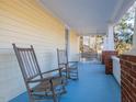 Relaxing porch with rocking chairs and swing at 298 E Salisbury St, Pittsboro, NC 27312