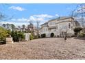 Expansive backyard featuring a white pergola and lush landscaping at 302 Edinburgh Dr, Cary, NC 27511