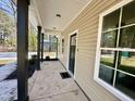 Inviting front porch view with dark columns, a 'Welcome' mat, and lots of natural light at 314 S Darden St, Kenly, NC 27542